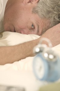 Man Waking to Alarm Clock